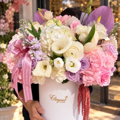 Large pastel bouquet in a white hatbox with pink ribbon