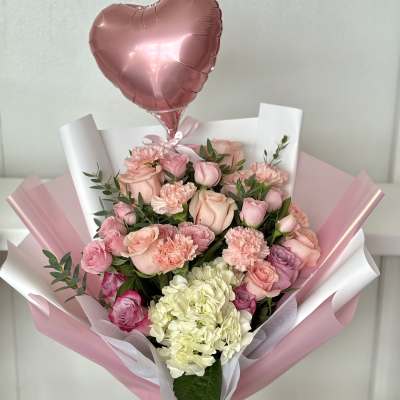 Pink bouquet with roses, carnations, hydrangea, and a heart balloon