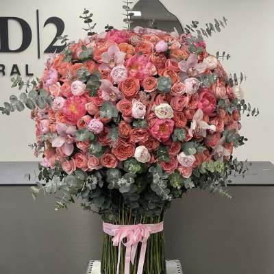 Large pink and coral rose bouquet with eucalyptus and a pink ribbon