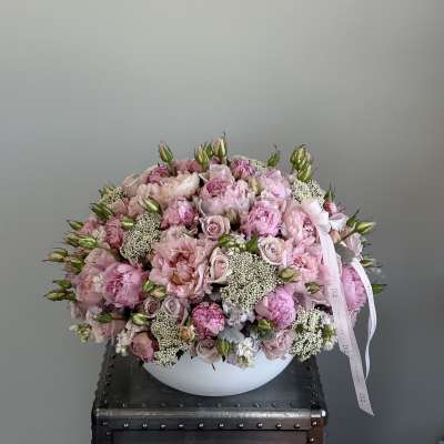 Large pink bouquet of roses and peonies in a white bowl