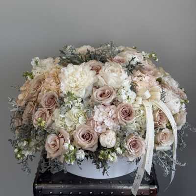 Large pastel bouquet of roses, peonies, and hydrangeas in a white box