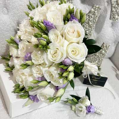 White rose bouquet with lavender accents and a matching boutonniere