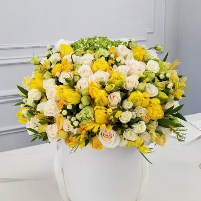 Large bouquet of yellow and white roses in a white hatbox
