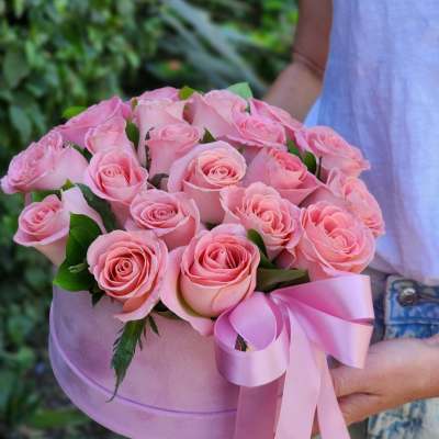 Pink rose bouquet in a round pink box with a ribbon