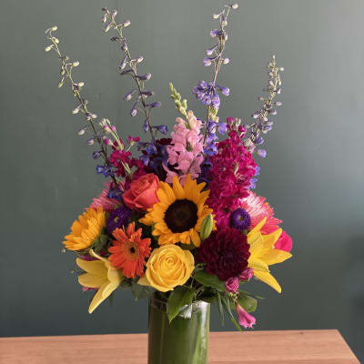 Colorful mixed bouquet in a tall glass vase
