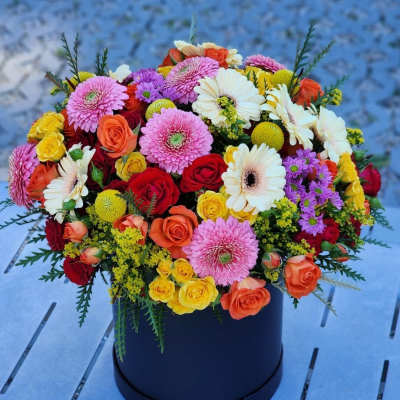 Colorful mixed bouquet in a black round box