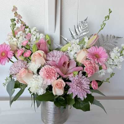 Pink and white mixed flower arrangement in a silver vase