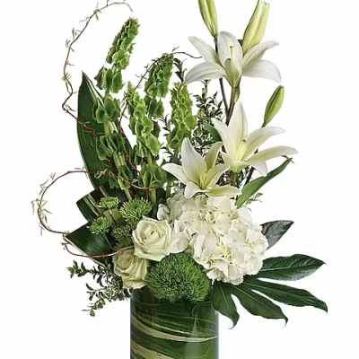 White lilies and hydrangeas in a green glass vase