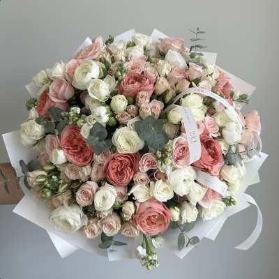 Large bouquet of pink and white roses wrapped in white paper