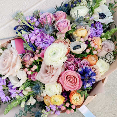Mixed bouquet of pink, white, purple, and orange flowers