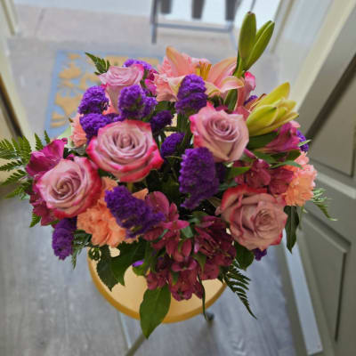 Bouquet of pink roses, lilies, and purple flowers