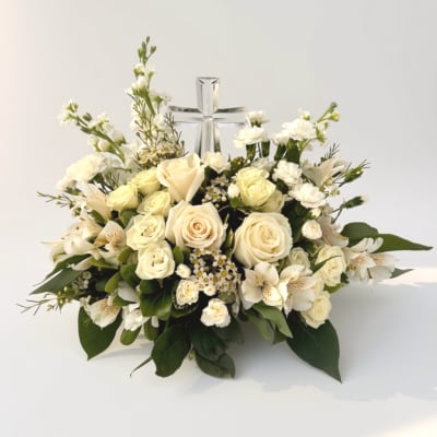 Cream rose and white flower arrangement with a clear glass cross