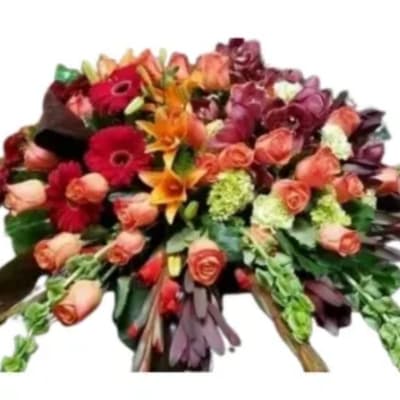 Mixed bouquet of roses, gerbera daisies, and lilies in warm colors