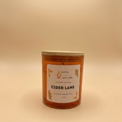 Amber candle in a glass jar with a wooden lid