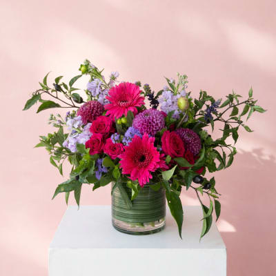 Pink and purple mixed bouquet in a glass vase