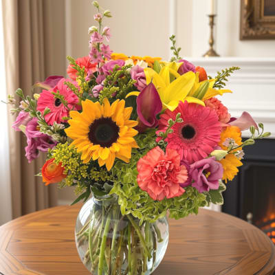 Colorful mixed bouquet in a clear glass vase on a table
