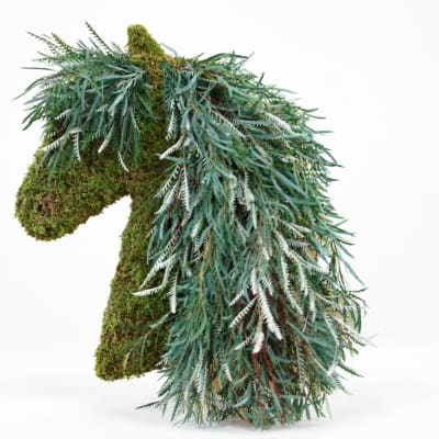 Moss-covered horse sculpture draped with cascading greenery