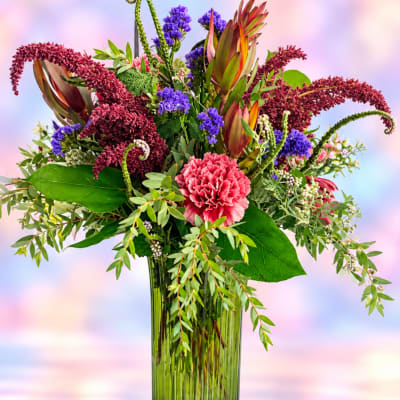 Colorful mixed bouquet in a tall glass vase