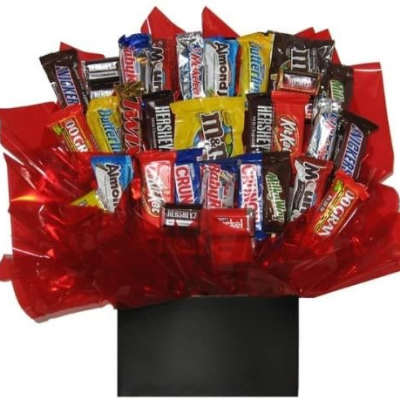 Assorted candy bars arranged in red wrapping with a black box base