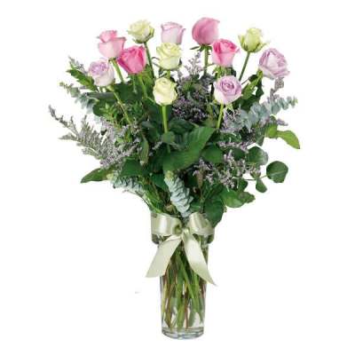 Bouquet of pink and lavender roses in a glass vase with a ribbon