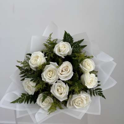 Bouquet of white roses with greenery and white wrap