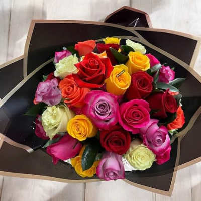 Hand-tied bouquet of mixed-color roses wrapped in black and gold paper