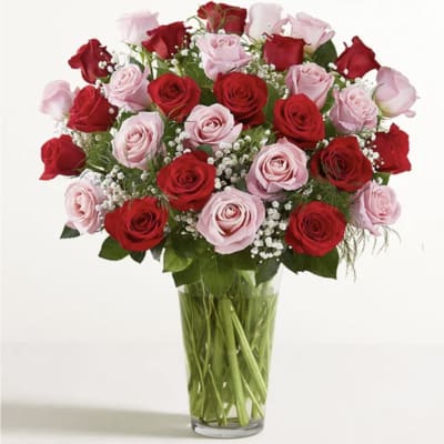 Bouquet of red and pink roses in a clear glass vase