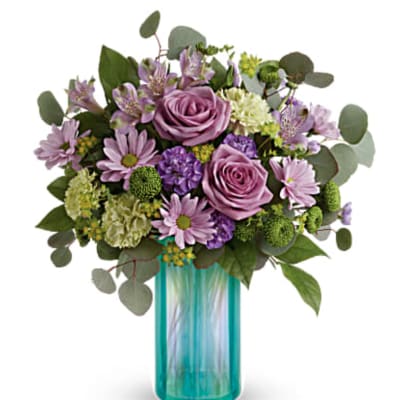 Lavender and pink bouquet in a turquoise glass vase