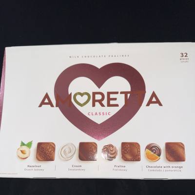 Box of Amoretta milk chocolate pralines with heart graphic