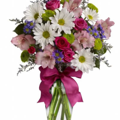 Bouquet of daisies, pink roses, and alstroemeria in a glass vase