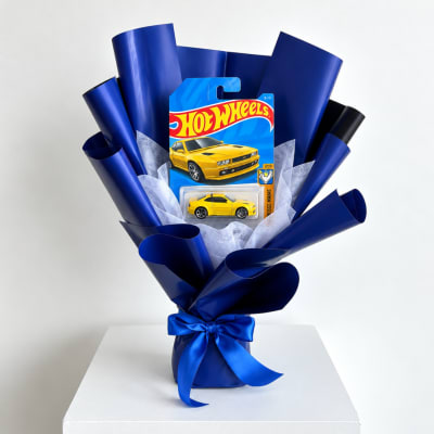 Hot Wheels toy car gift bouquet wrapped in blue paper with a ribbon