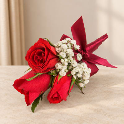 Red rose bouquet with white filler flowers and a red ribbon wrap