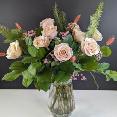 Bouquet of pale blush roses in a clear glass vase