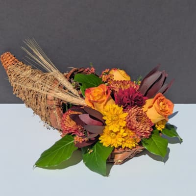 Cornucopia basket with orange roses and yellow chrysanthemums