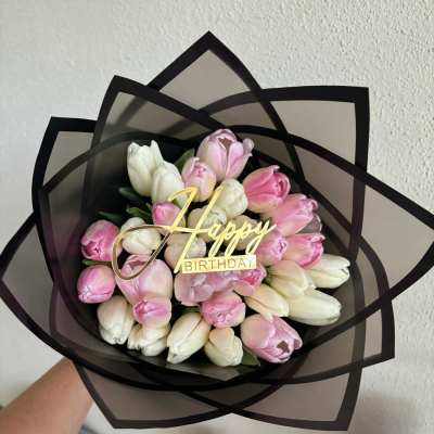 Bouquet of pink and white tulips with a Happy Birthday topper