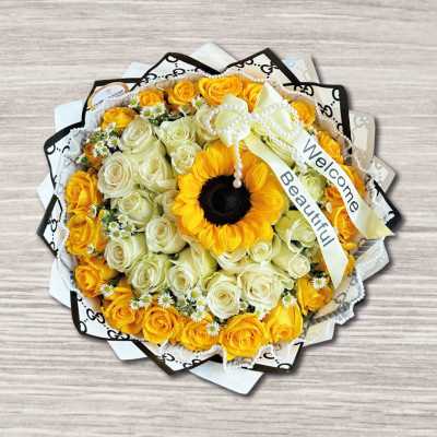 Bouquet of yellow and white roses with a sunflower center and ribbon