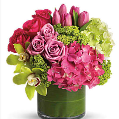 Pink roses and tulips with hydrangea in a glass vase