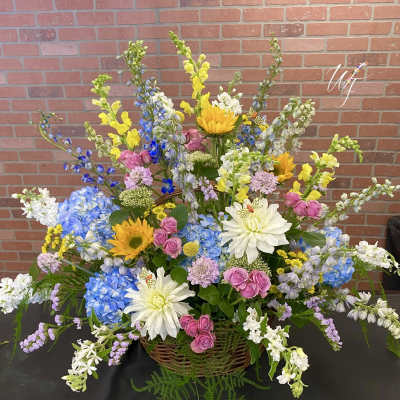 Large mixed flower basket with blue, yellow, pink, and white blooms