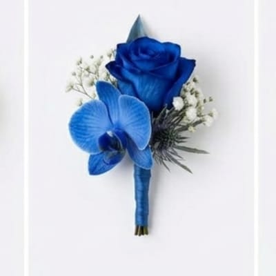 Blue rose and orchid boutonniere with white filler flowers