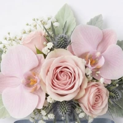 Soft pink roses and orchids arranged in a bridal bouquet