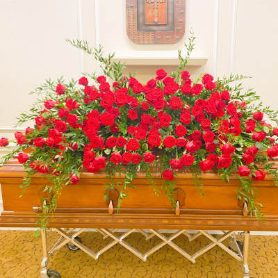 Large red rose spray on a casket