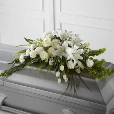 White floral spray on a gray casket