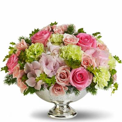 Pink and blush roses with green carnations in a silver pedestal bowl