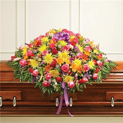 Large colorful floral casket spray with a purple ribbon