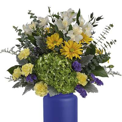 Bouquet of white and yellow flowers in a blue vase