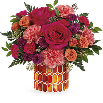 Pink and orange roses with carnations in a mosaic glass vase