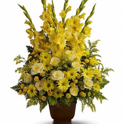 Yellow floral arrangement in a brown urn vase
