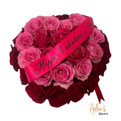Bouquet of pink and red roses with a Valentine ribbon