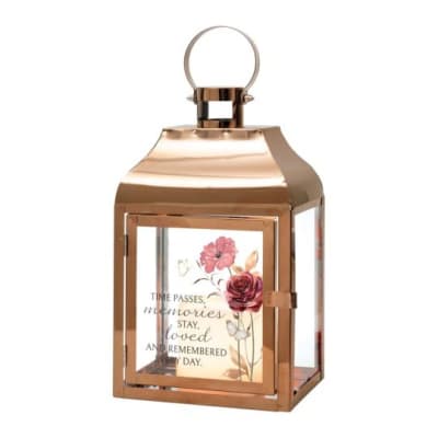 Rose gold memorial lantern with floral artwork and an inscription about memories and love on the glass panel.