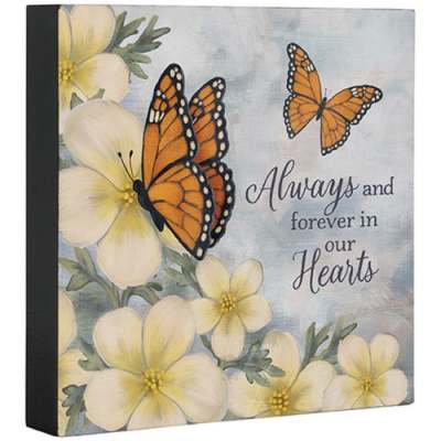 Square decorative plaque with yellow flowers, orange butterflies, and memorial text.